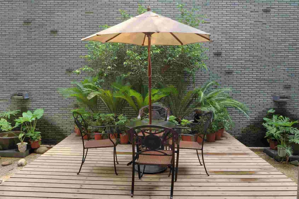 House patio with  table and chairs under umbrella