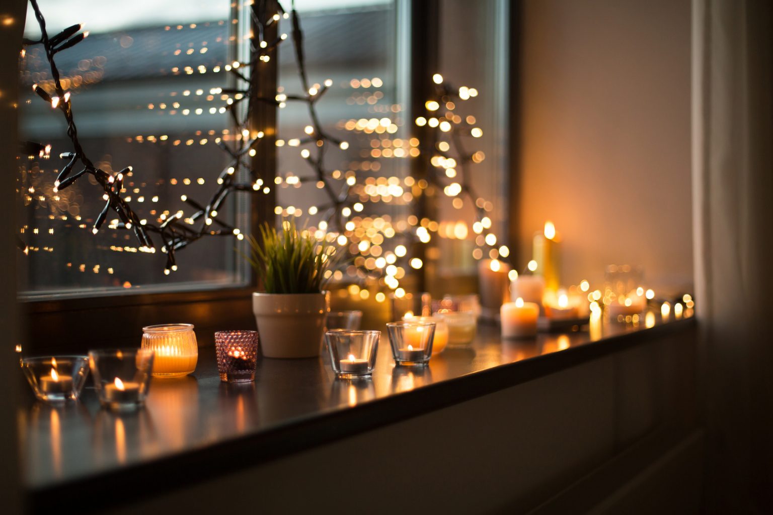 Candles Burning On Window Sill With Garland Lights | M Jak Mrówka